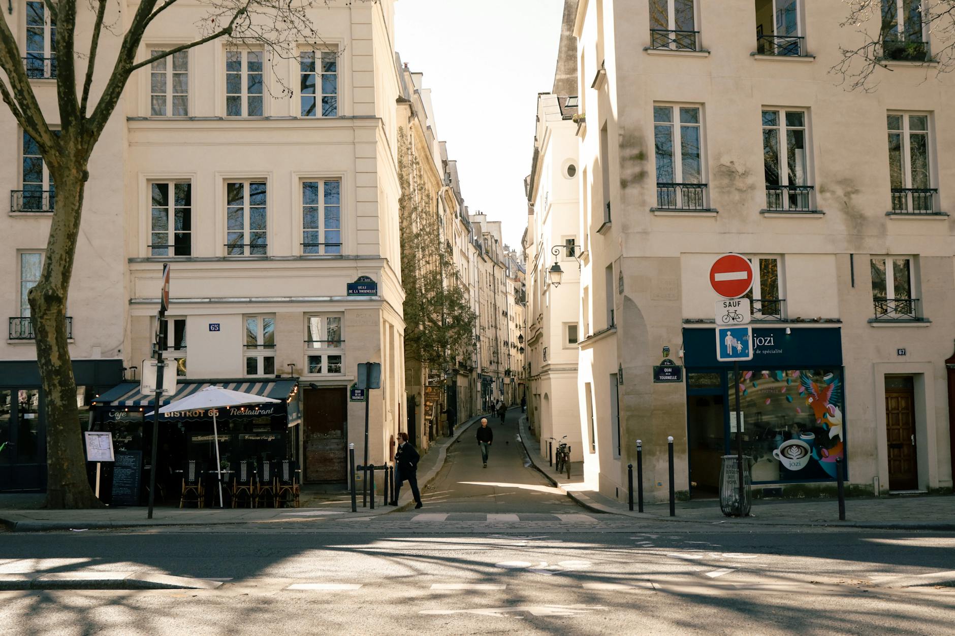 Sidewalk cafe terrace on a sunny Paris morning with well-dressed locals