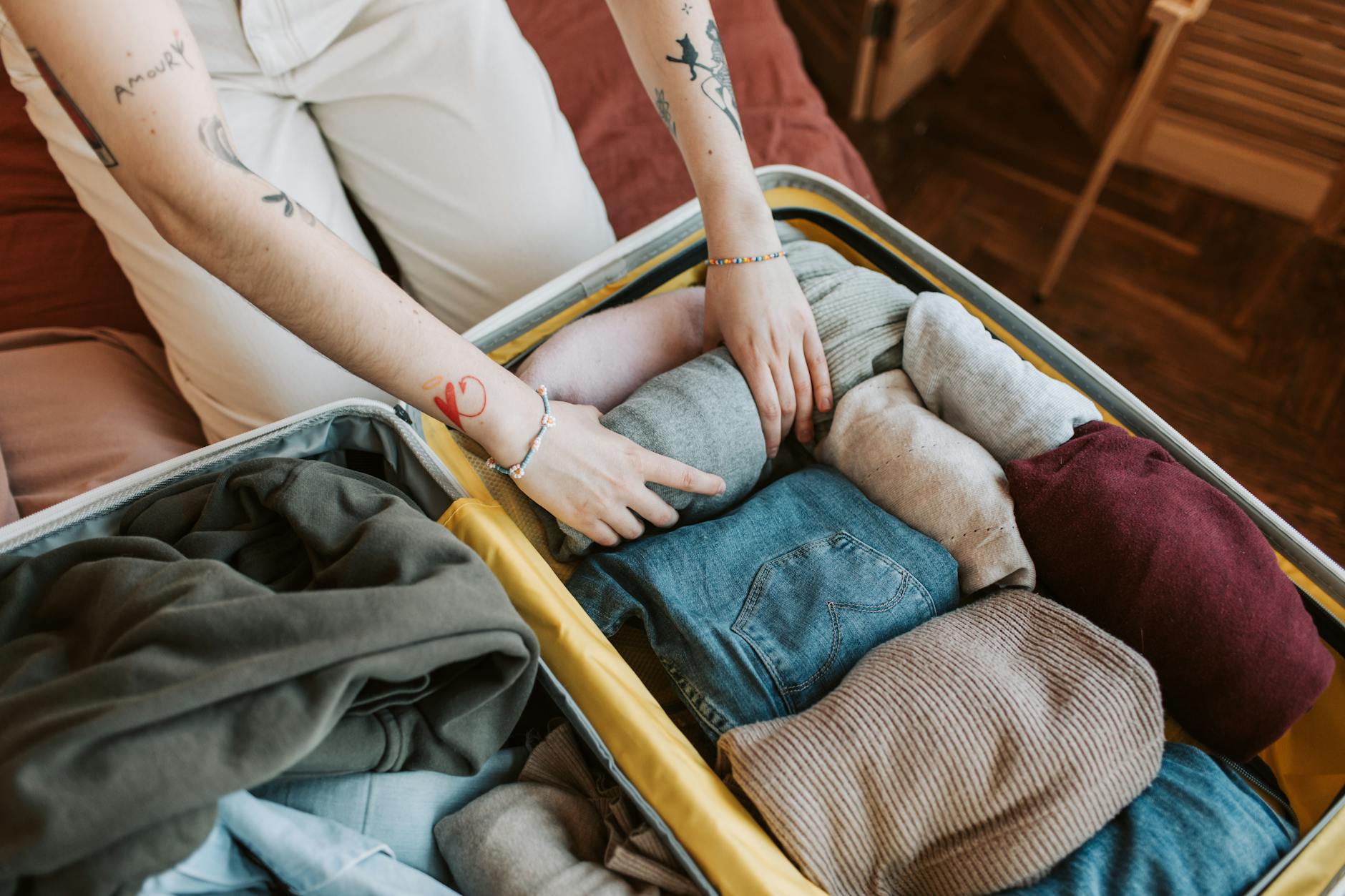 Stylish traveler with a capsule wardrobe suitcase overlooking a Parisian boulevard